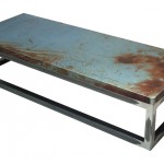 Three quarter view of an industrial table made with the trunk of a Chevrolet Nova 1976 car.